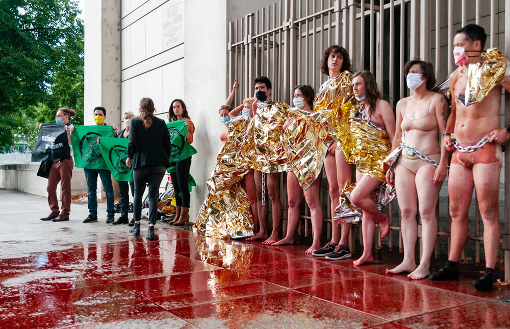 French rebels, almost nude, wtih a large puddle of fake blood in front